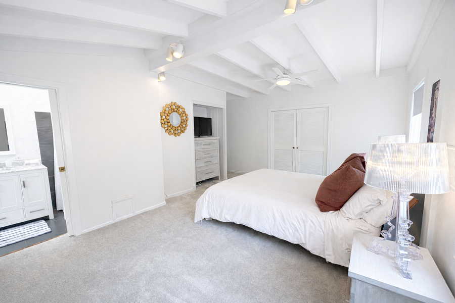 Unwind in your serene bedroom with vaulted ceilings, plush bedding, and elegant furnishings creating the perfect retreat for restful nights.