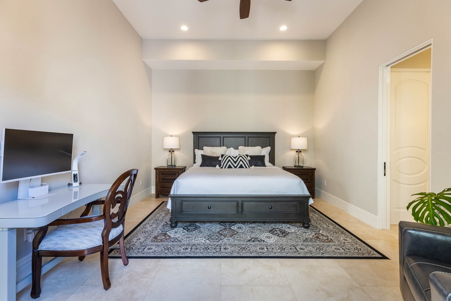 Guest bedroom with a king bed and a dedicated home office space.