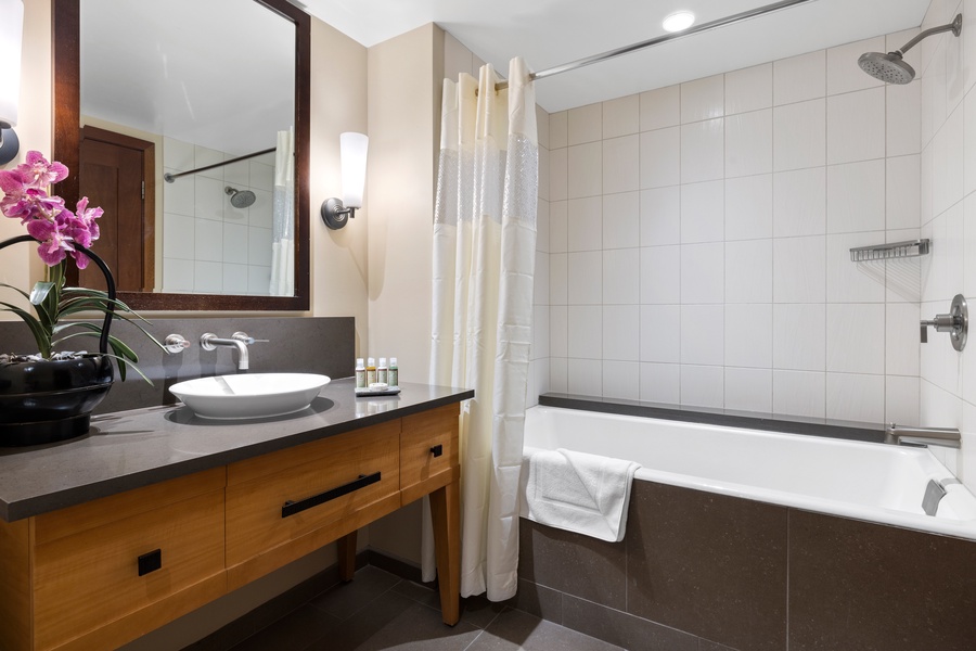 The second guest bathroom has a shower-tub combo.