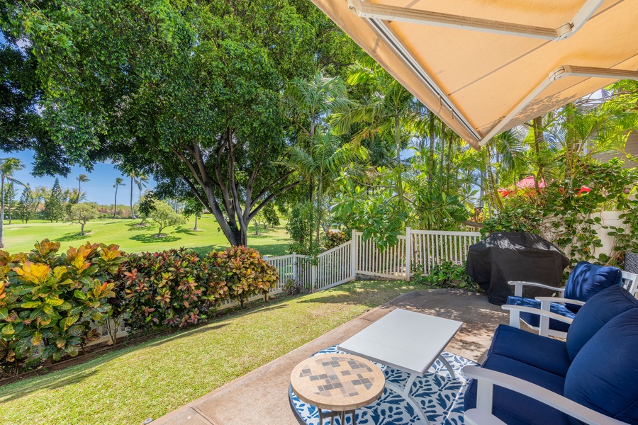 Seating on the lanai surrounded by lush greenery.