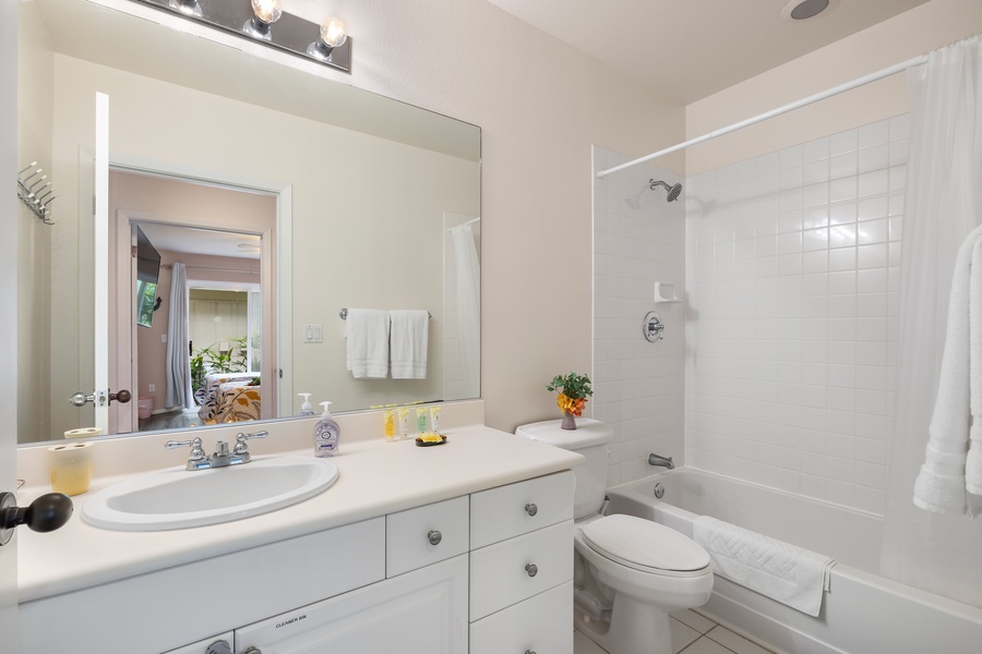 Bright and clean full bathroom with tub/shower combo—great for families or post-beach rinses.