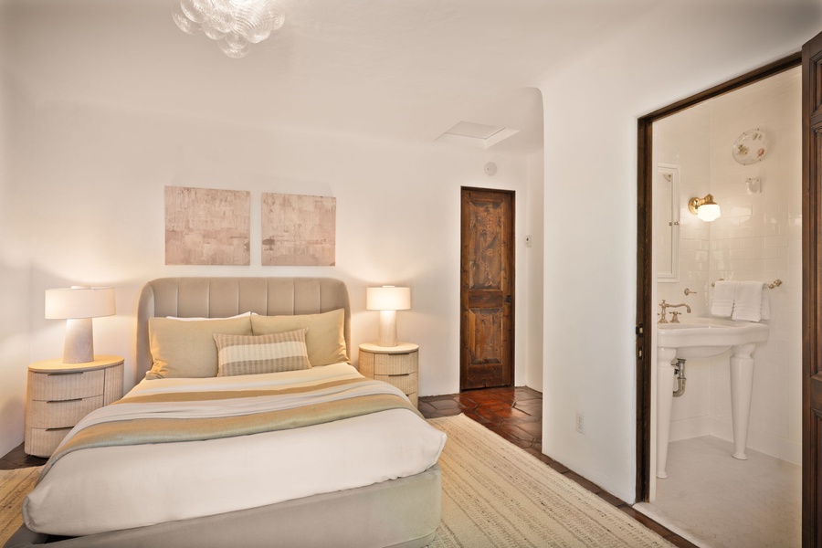 Sink into crisp linens and soft lighting in your serene bedroom, complete with an elegant ensuite bathroom for your comfort.