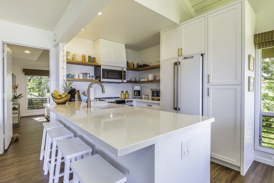 The galley-style kitchen is fully equipped for meal preparation, with newly installed spacious custom cabinets and appliances for all of your needs, including a dishwasher
