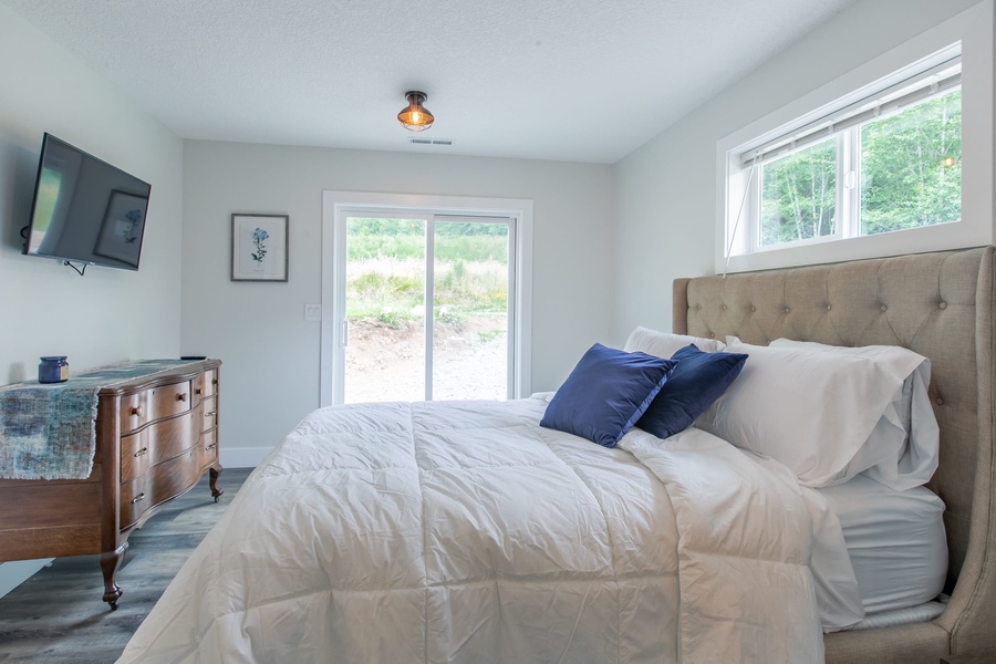 Guest Bedroom comes with a queen bed and Sliding Glass door to the forest!