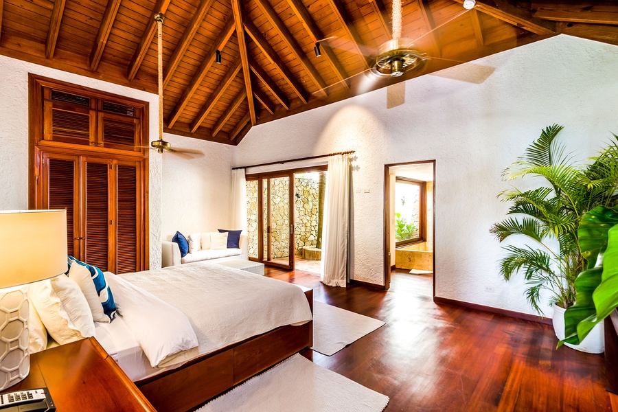 Bright and airy guest bedroom with a private garden view.