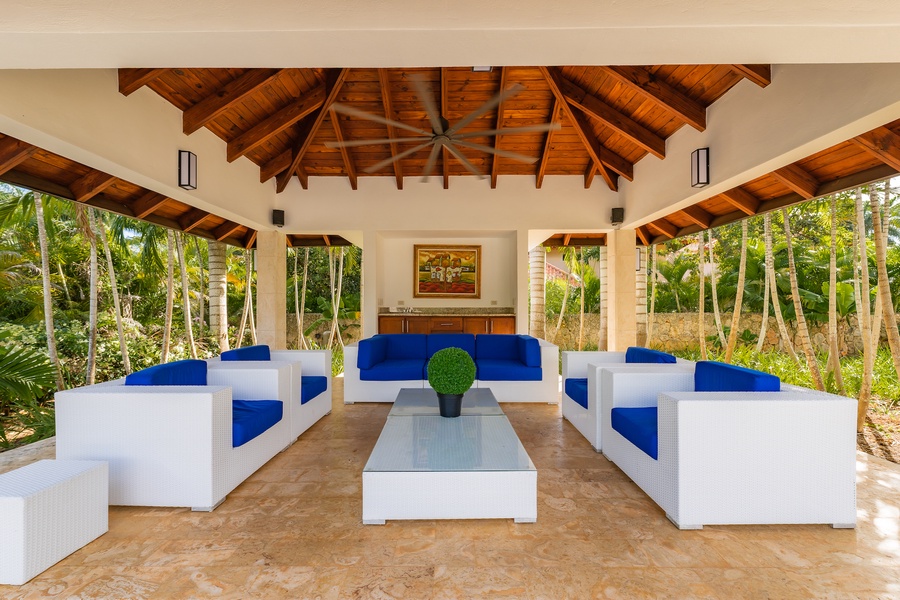 Cozy outdoor seating area with a high wooden ceiling.