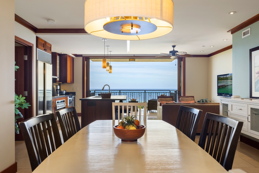Your open-concept living space seamlessly blends kitchen and dining with breathtaking ocean views through floor-to-ceiling windows.