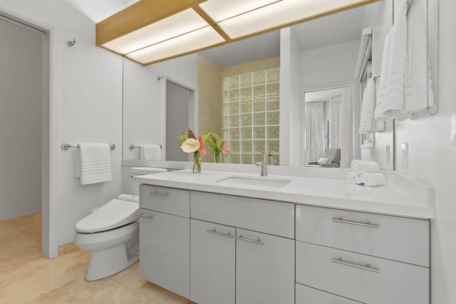 Contemporary fixtures and custom lighting create a polished and functional space for your daily rituals.