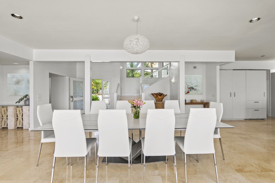 Gather around a sleek, modern dining table beneath crystal lighting—perfect for elegant meals and memorable conversations.