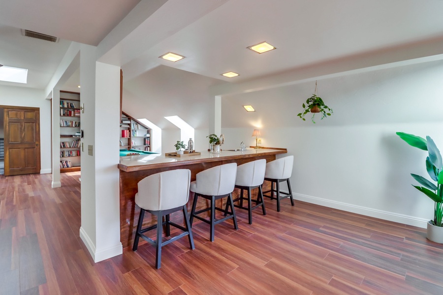 The wet bar has seating for four for casual chats and entertainment.