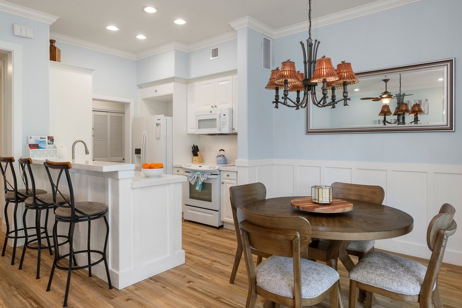 Gather around the breakfast bar, off the dining area, in this fully upgraded kitchen with sleek quartz countertops and modern appliances.