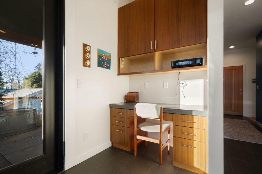 Your dedicated workspace features warm wood cabinetry and natural light, creating the perfect spot for remote work or planning adventures.