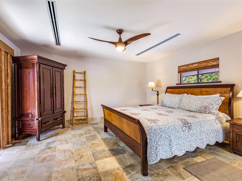 Downstairs guest bedroom with King bed, A?C, TV, Lanai access, and ensuite