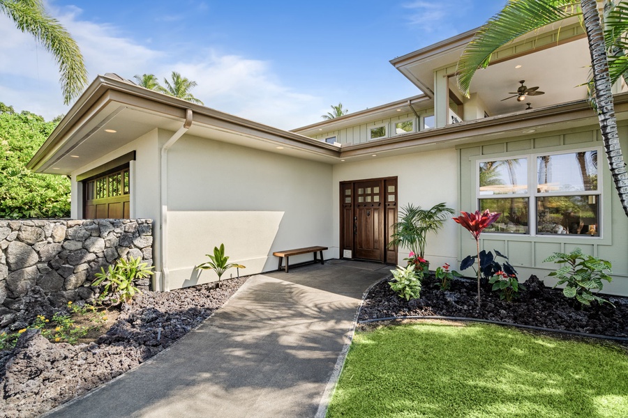 Stunning front entrance showcasing the home’s modern design and lush landscaping.