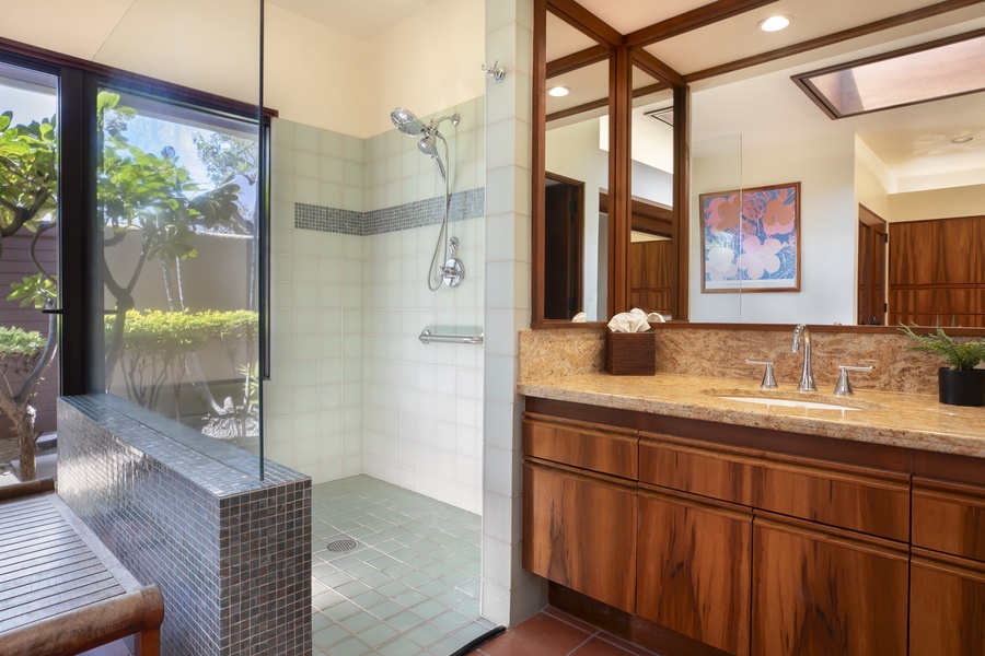 Spa-style ensuite with a walk-in shower and elegant wood cabinetry—ideal for unwinding after a day on the coast.