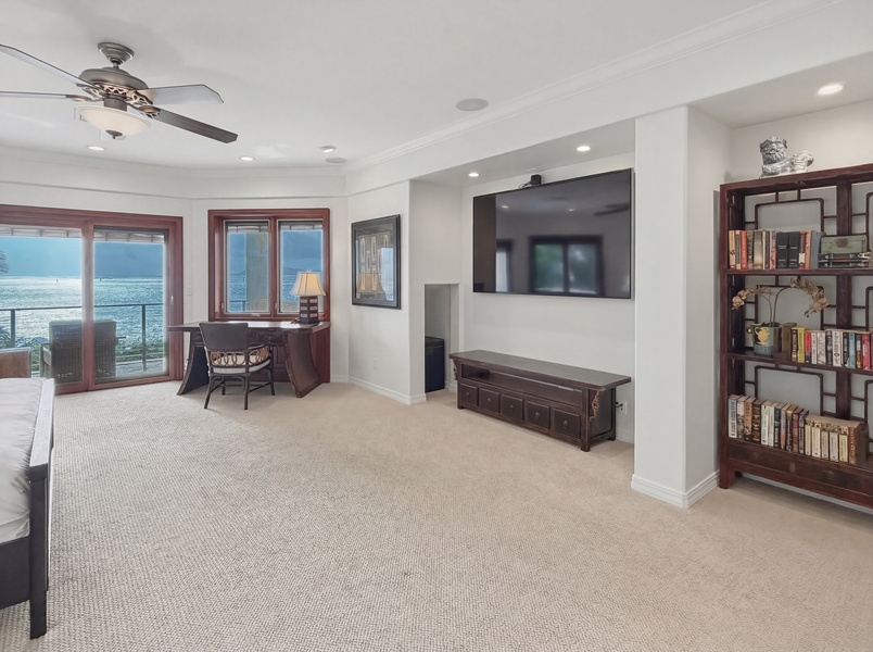 Unwind in your spacious living area with stunning ocean views and entertainment center for cozy evenings.