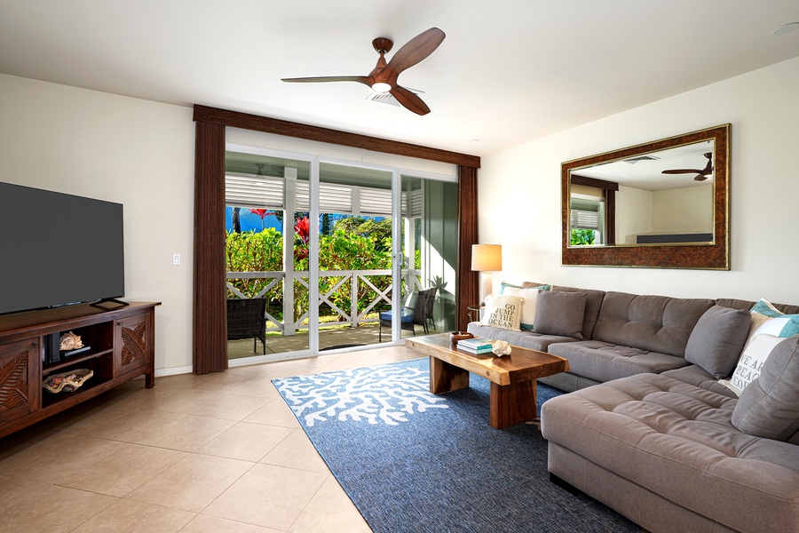 The living area is open to the lanai with large sliders and plentiful seating.