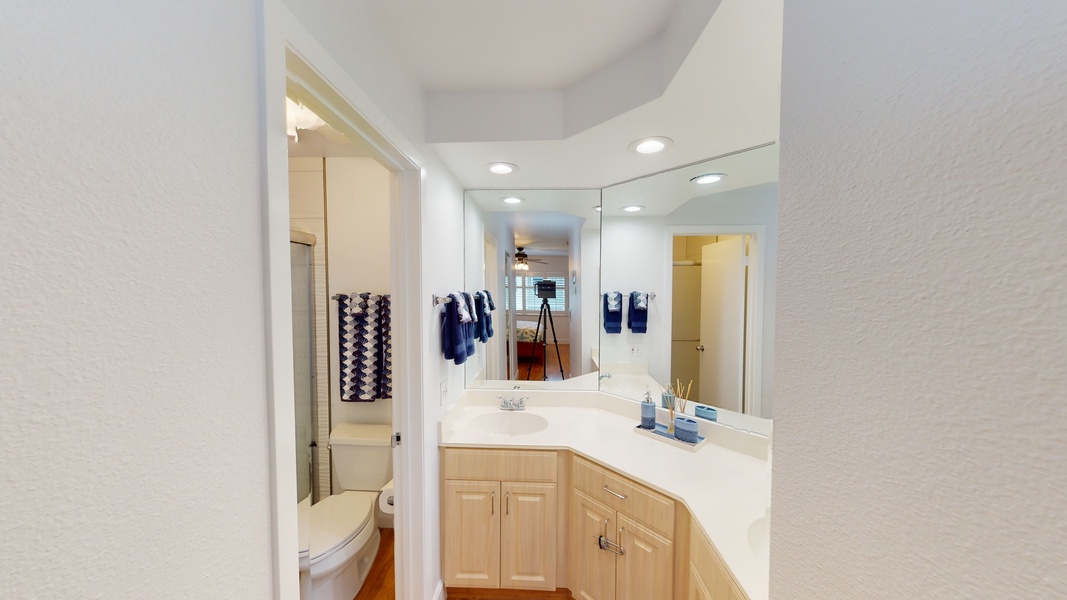 The primary guest bathroom has a double vanity and ample lighting.
