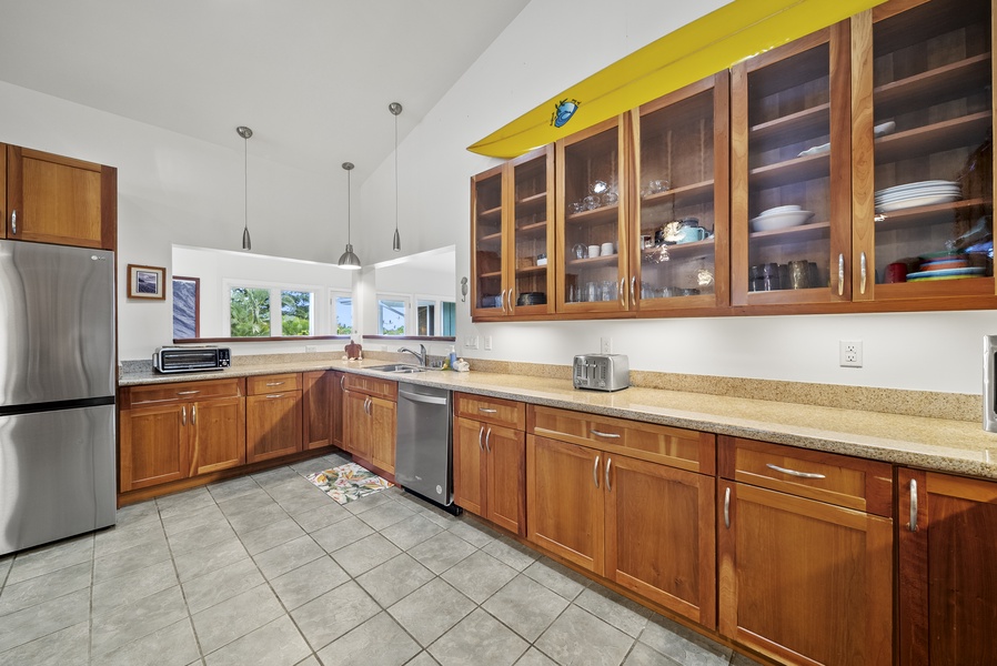 Chef’s kitchen with warm wood cabinetry, stainless appliances, and plenty of counter space.