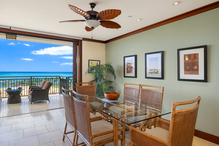 Enjoy intimate meals with stunning ocean views from your elegant dining space, where tropical breezes flow through open balcony doors.