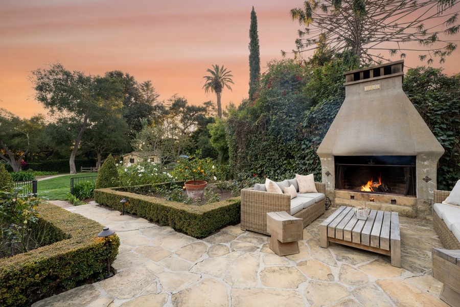 Unwind by your private outdoor fireplace as golden sunset paints the sky, surrounded by lush gardens and elegant stone patios.