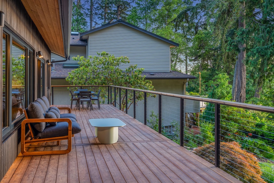 Spacious deck surrounded by nature, perfect for outdoor dining and relaxation.