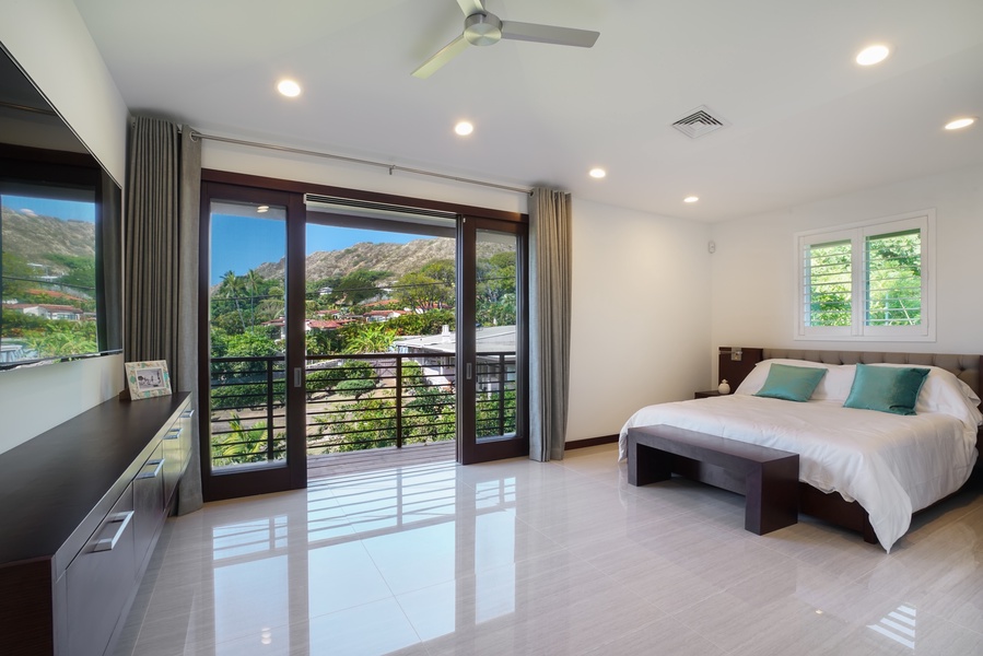 Guest bedroom with balcony access, garden views, and natural light—peaceful and private.
