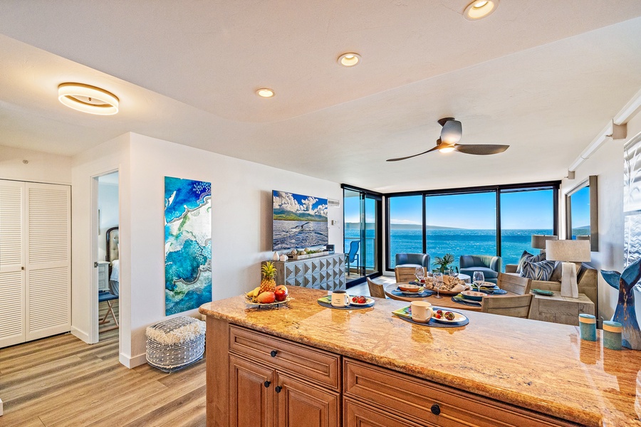 This inviting open-concept space blends the kitchen and living areas seamlessly, offering a bright, airy ambiance and uninterrupted ocean views