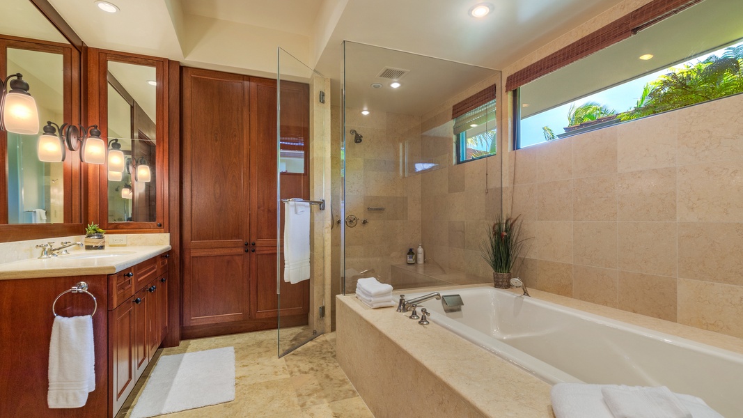Separate walk-in shower and dual vanity in the primary.
