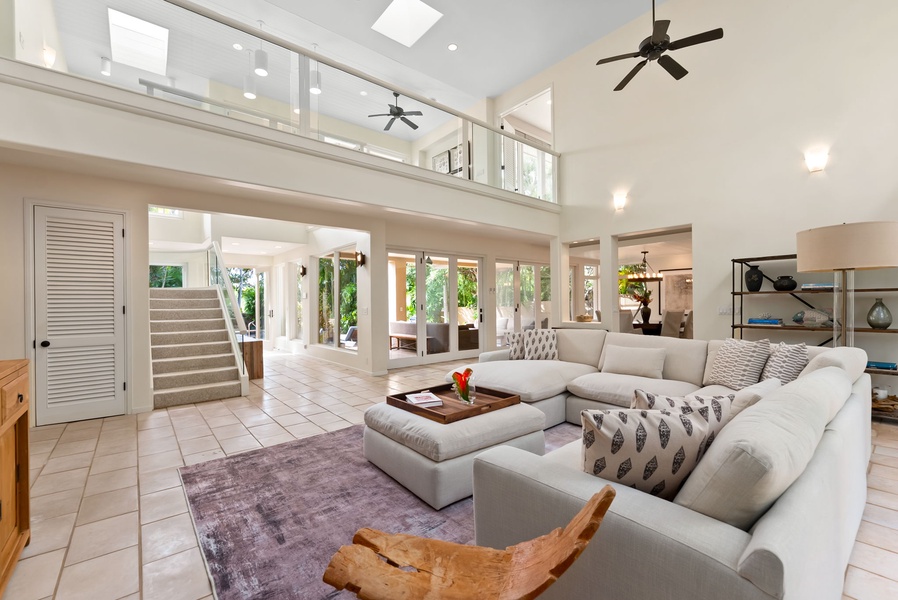 Spacious open-plan living area with soaring ceilings, natural light, and modern comfort.
