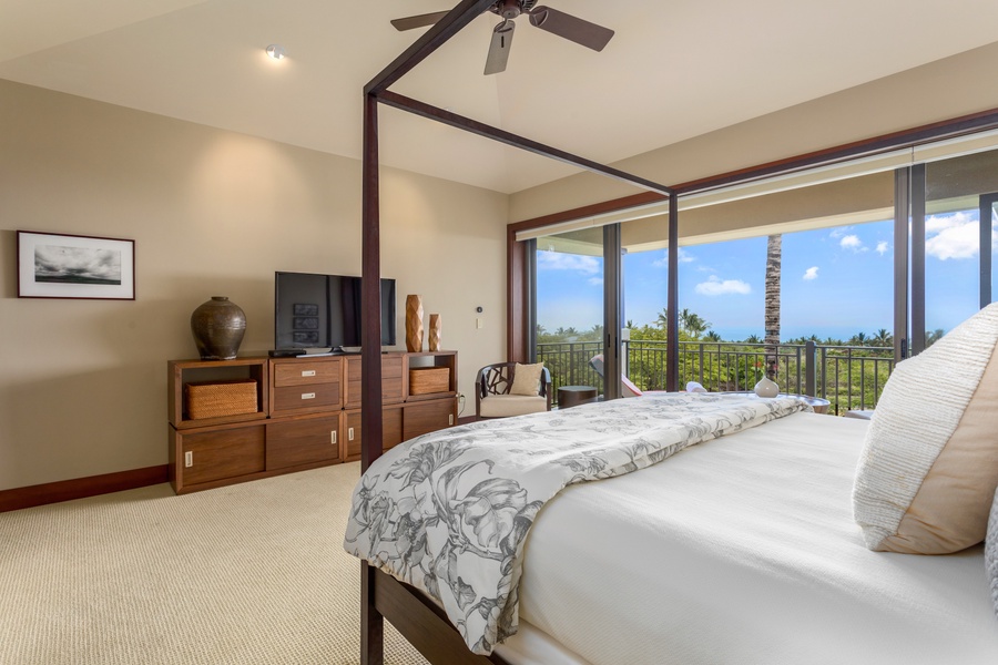 Blue skies and ocean views from the decadent king-sized primary bed.