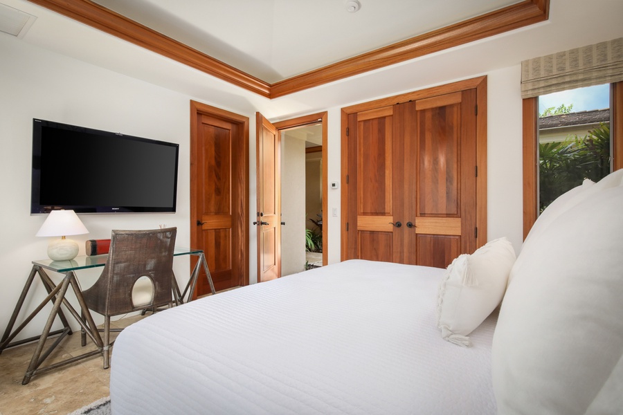 Reverse view of Guest Suite #3 showcasing large wall mounted television and desk.