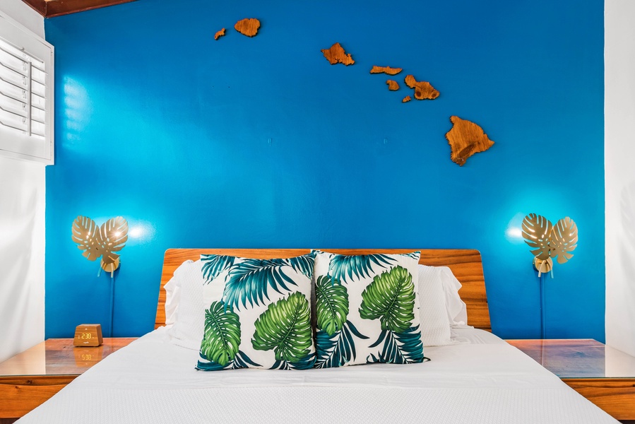 A vibrant bedroom featuring tropical-themed decor and a unique wall art of the Hawaiian Islands, creating a warm and inviting atmosphere.