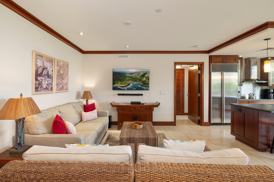 Sink into plush seating where warm wood accents meet tropical elegance, creating your perfect retreat for movie nights and morning coffee.