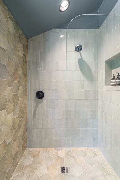 Walk-in shower adjacent to the hot tub.