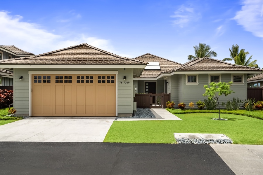 The house sits behind an easy front lawn, drive and garage ready when you pull in.
