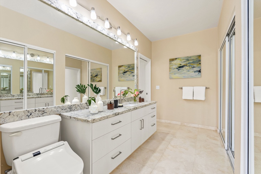 The primary bathroom features double vanities, ample storage, and sophisticated finishes—your personal spa retreat.