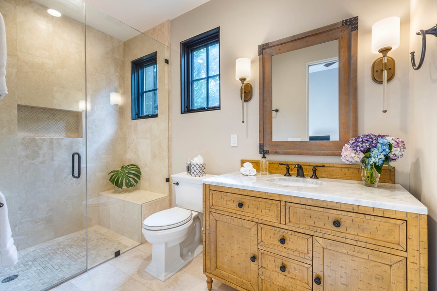 Ensuite bath with a walk-in shower in a glass enclosure.