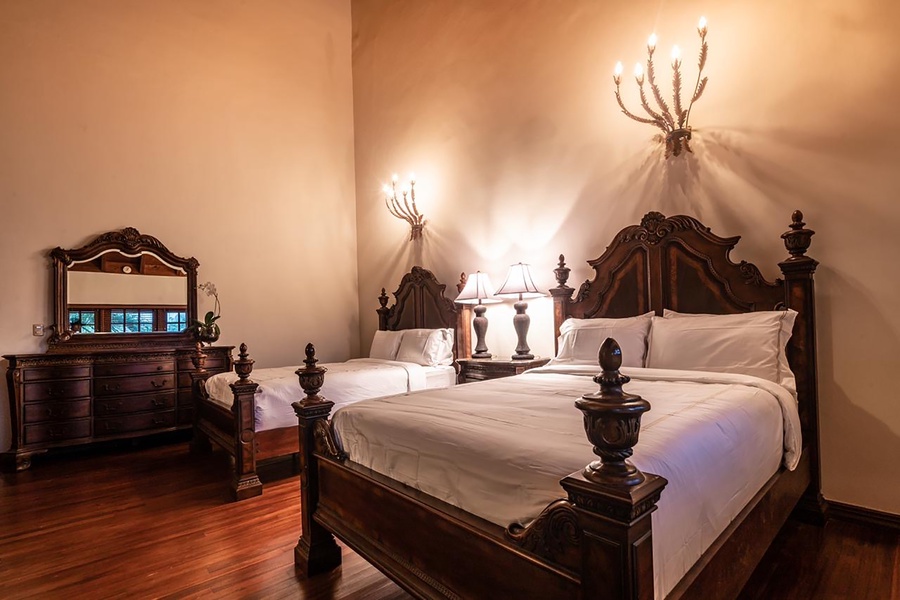 This guest bedroom also features a classic dresser and decor.