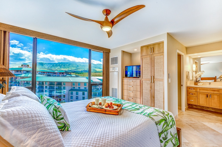 The guest room at Mahana 1119 features a comfy queen bed and picture window with outdoor views.