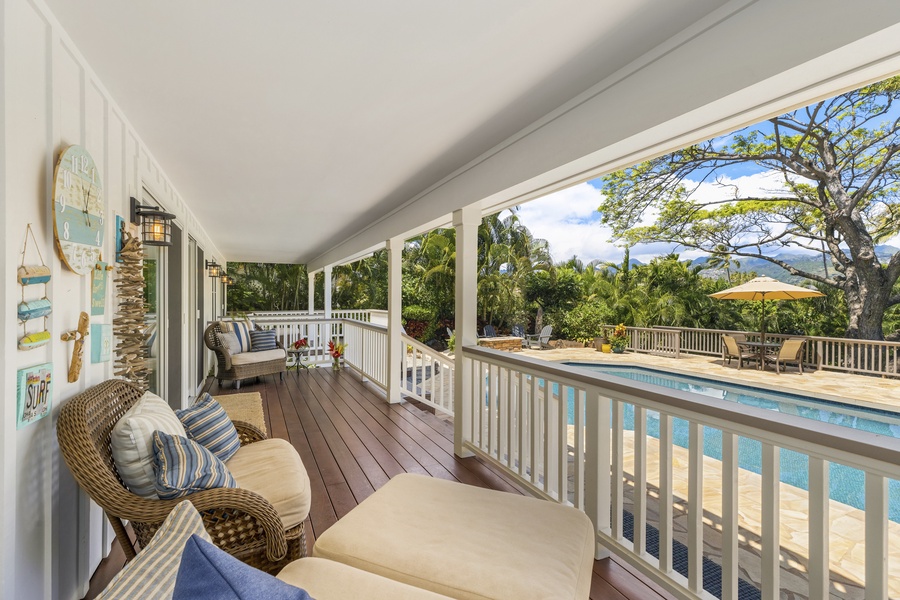 Expansive deck overlooks the private pool, fire pit, and yard