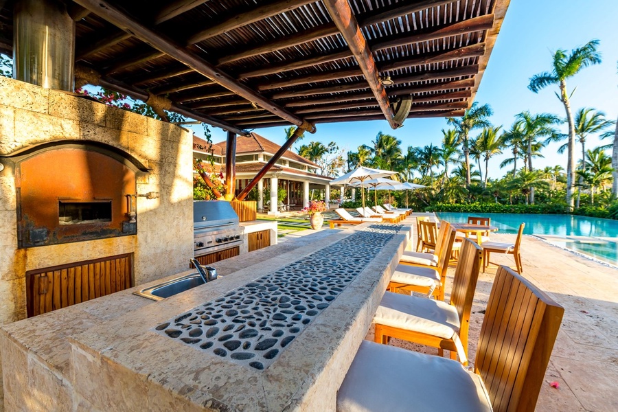 Seamless access from the outdoor kitchen to the pool area.