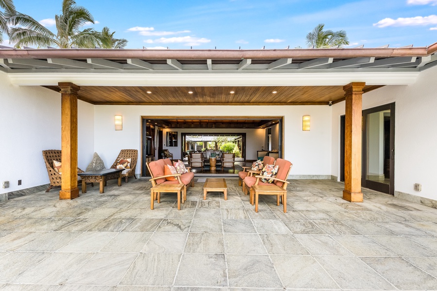 Elegant stone terrace with lounge seating for effortless indoor-outdoor living.