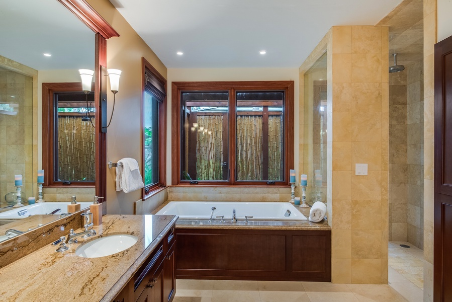 Clse-Up of Downstairs Primary Bath w/ Soaking Tub and Windows to Bamboo Enclosed Outdoor Shower