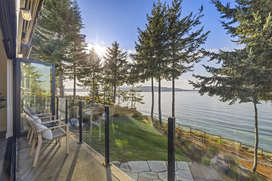 Expansive backyard with glass railing and bay views — a peaceful space to enjoy the Pacific Northwest breeze.