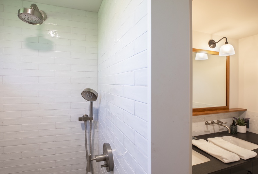 Modern rain shower with clean tile design and an open, airy feel.