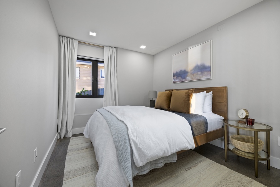 Inviting queen bedroom with warm tones and modern decor for a peaceful night’s sleep.