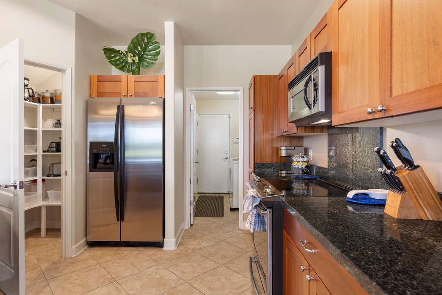 Your fully-equipped kitchen features warm wood cabinets, granite counters, and modern appliances—perfect for preparing memorable meals together.