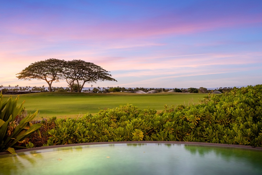 Views of the sunset, golf course and the deep blue Pacific Ocean beyond.