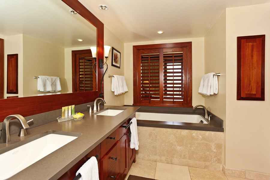 The primary guest bathroom with a lovely soaking tub and double vanity.